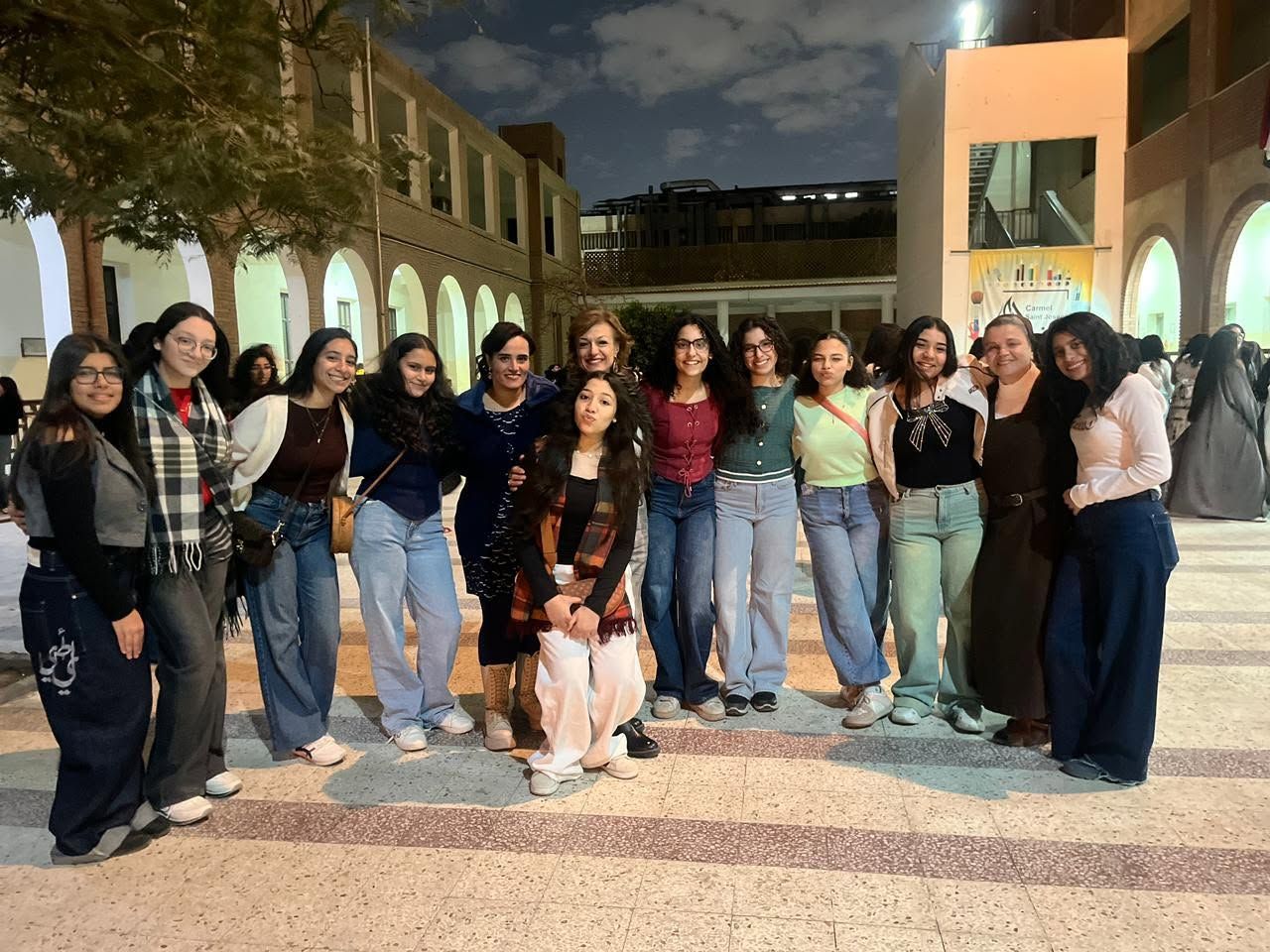 Evening gathering of students under the school arches