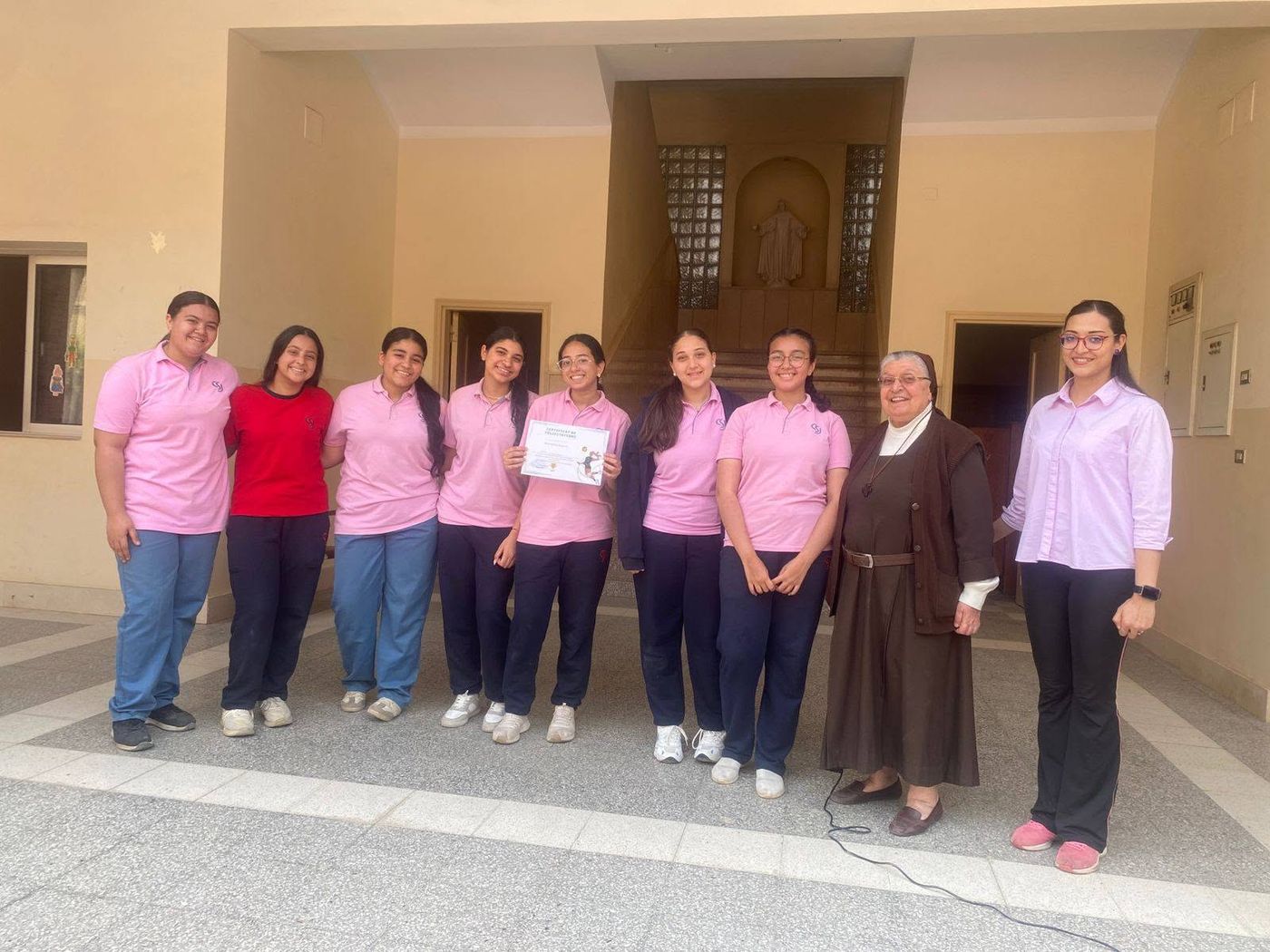 Students and sisters in the historic school courtyard