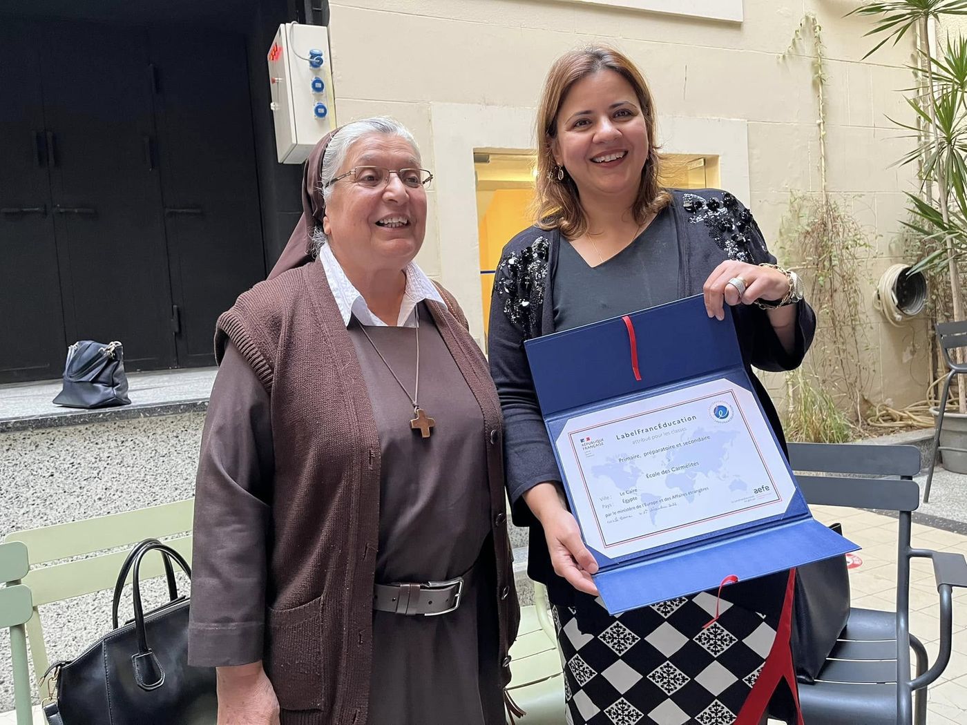 Teachers and sisters gathered in the courtyard with the certificate