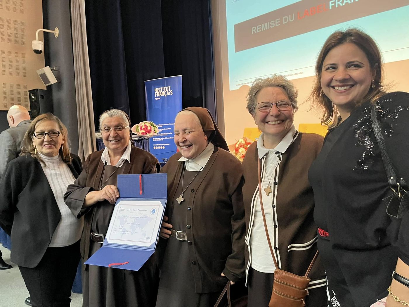 Sisters proudly holding the LabelFrancÉducation award